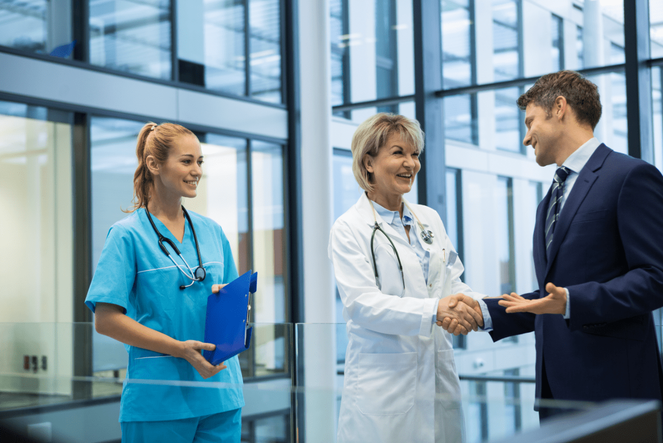 female-doctor-shaking-hands-with-businessman-2021-08-28-18-10-36-utc